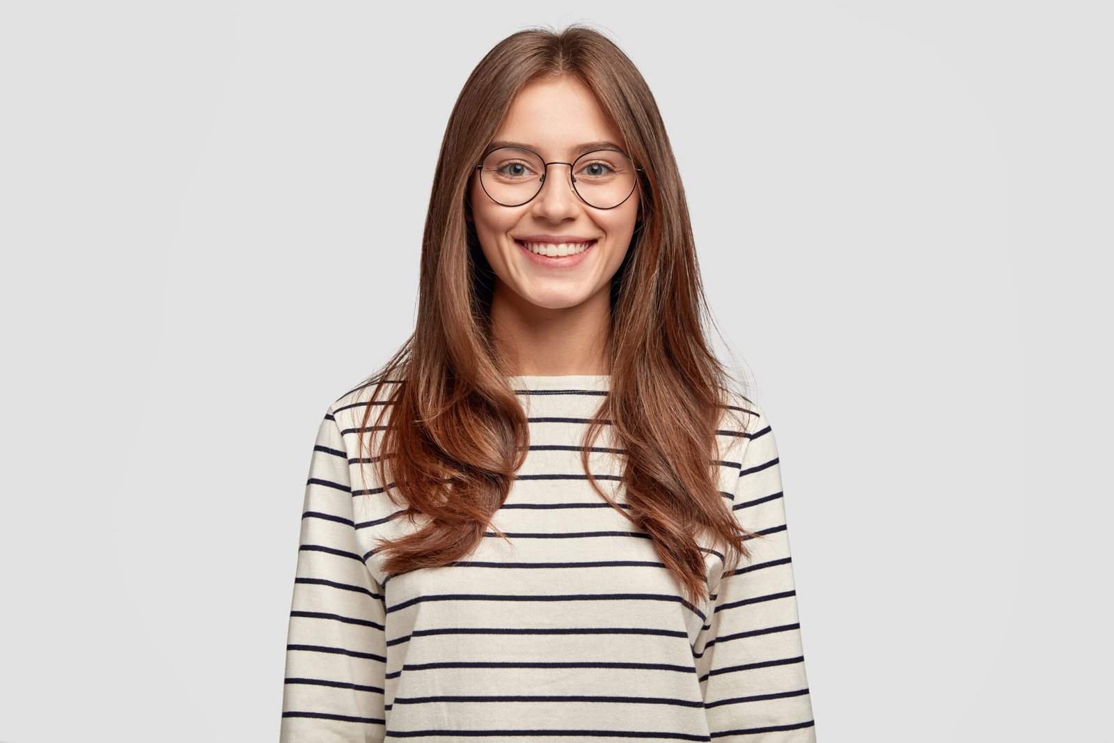 indoor-shot-attractive-young-woman-with-glasses-posing-against-white-wall-scaled